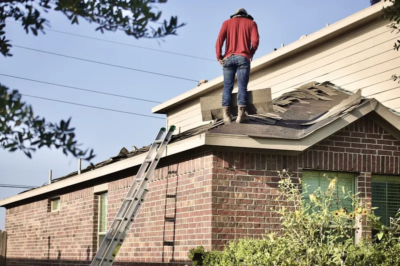 Professional roofer working on a residential roof in Oconee Heights